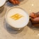 A cup of coffee with latte art of the Disney Cruise Line logo